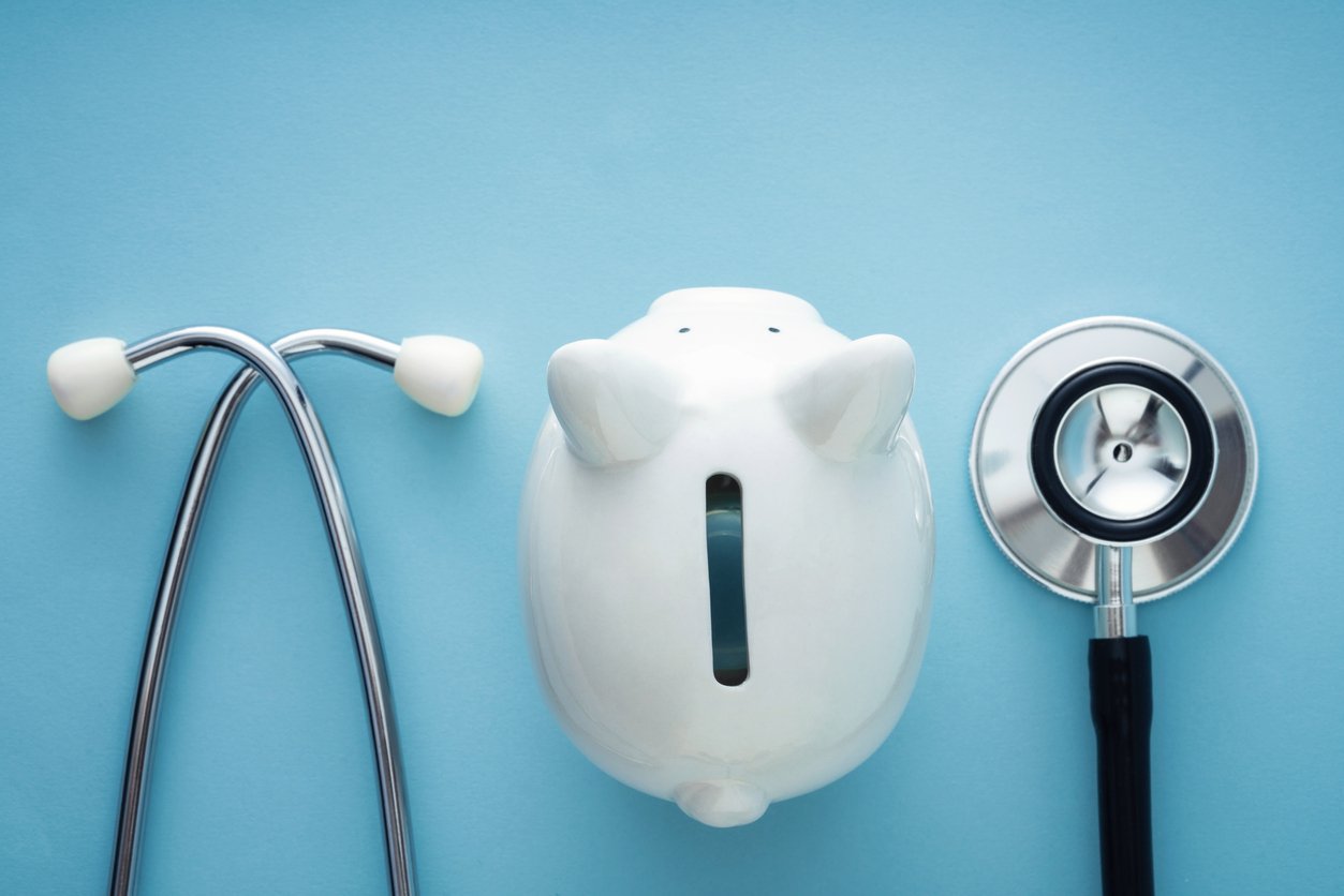 Doctor's stethoscope and piggy bank